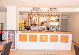 a bar in a restaurant with a counter at Aquamar Albufeira Aparthotel in Albufeira