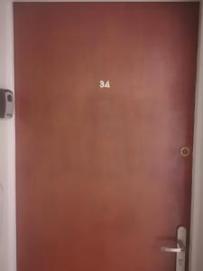 a brown door with the number on it at ESCALE AU GRAU DU ROI in Le Grau-du-Roi