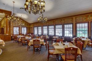 a dining room with tables and chairs and a chandelier at Y O Ranch Hotel and Conference Center in Kerrville