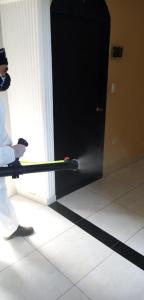 a person holding a baseball bat in front of a door at Hotel Espa&ntilde;ol Neiva in Neiva