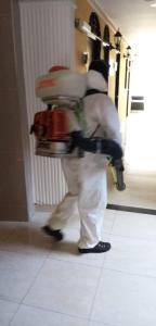 a man walking down a hallway with a pile of luggage at Hotel Español Neiva in Neiva