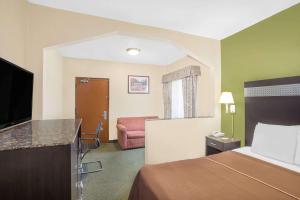 a hotel room with a bed and a television at Howard Johnson by Wyndham North Bergen in North Bergen