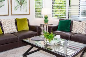 a living room filled with furniture and flowers at Bella Casa Noosa in Noosa Heads