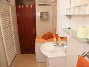a bathroom with a sink and a wooden door at Prestige Apartman Zagreb in Zagreb +33 photos