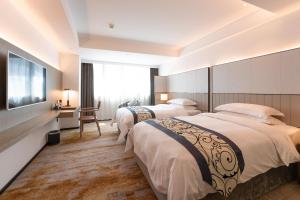 Un pat sau paturi într-o cameră la Zhong Tai Lai Hotel Shenzhen