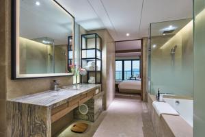 a bathroom with a large sink and a shower at Crowne Plaza Ningbo Xiangshan Sea View, an IHG Hotel in Xiangshan