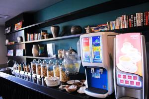 a coffee machine sitting next to a shelf with books at Suites by Watermark Hotel and Spa in Jimbaran