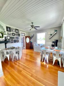 a dining room with white tables and white chairs at The Panguitch House in Panguitch