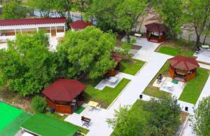 an overhead view of a building with a yard with trees at Lime Hotel in Khabarovsk