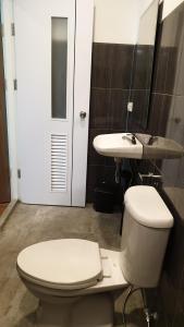 a bathroom with a toilet and a sink at Nature Village Hostel in Lak Si