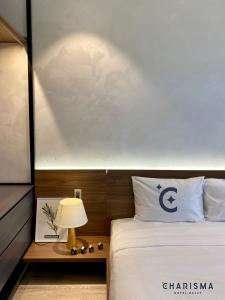 Postel nebo postele na pokoji v ubytování Charisma Hotel Da Lat