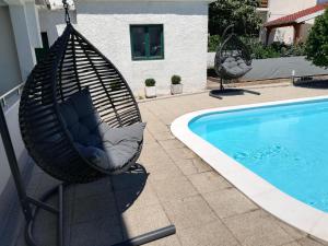 a hammock next to a swimming pool at Stars Palace in Jezera