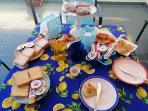 a blue table with plates of food on it at Il corallo azzurro in Reggio di Calabria
