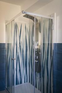 y baño con ducha y puerta de cristal. en Il corallo azzurro, en Reggio Calabria