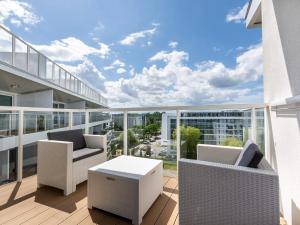 a balcony with chairs and a table on a building at VacationClub – Seaside Park Apartament 644 in Kołobrzeg