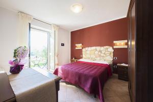 A bed or beds in a room at Agriturismo Il Fontanile