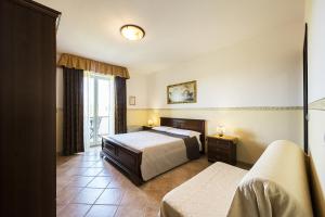 A bed or beds in a room at Agriturismo Il Fontanile