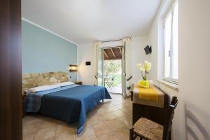 A bed or beds in a room at Agriturismo Il Fontanile