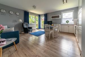 a living room with a blue couch and a table at Nautical Sea Apartment in Gdynia