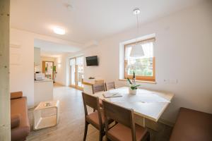 a dining room and living room with a table and chairs at Residence Plan De Corones in San Vigilio Di Marebbe