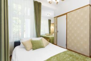 a bedroom with a white bed and a window at Villa Meri in Pärnu