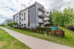 an apartment building with a fence in front of it at Nautical Sea Apartment in Gdynia