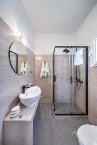 a bathroom with a sink and a shower at Letta's Apartments in Finikas