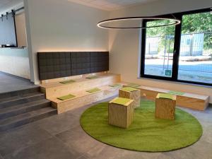 a room with three tables and a large window at a2 HOTELS Wernau am Quadrium in Wernau