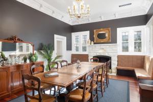 a dining room with a table and a fireplace at Delgattie Estate in Mount Gambier