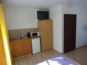 a small kitchen with a sink and a microwave at Ośrodek Korab in Władysławowo