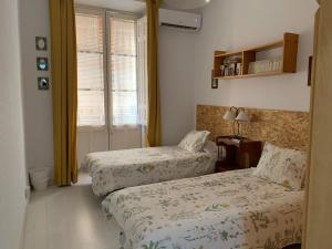 Ένα ή περισσότερα κρεβάτια σε δωμάτιο στο Corredera Rooms