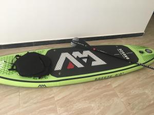 a paddle board sitting on the floor with a paddling device at Arabesque Style - 2 appartements in Kelibia