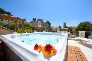 a hot tub with flowers on top of a house at Ravello House in Ravello