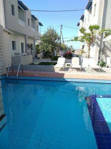 a swimming pool in the middle of a apartment at Nikolas Apartments in Amoudara Herakliou