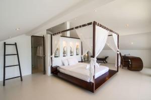 a bedroom with a canopy bed and a ladder at Malee Beach A4 in Ko Lanta +23 photos