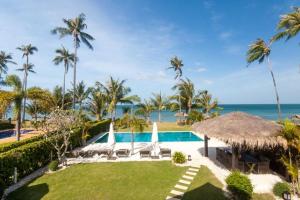an image of a resort with a swimming pool and the ocean at Malee Beach A4 in Ko Lanta
