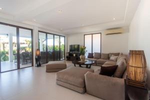 a living room with a couch and a table at Malee Beach A4 in Ko Lanta