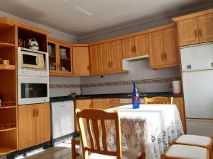 a kitchen with a table with a bottle of water on it at Casa Entremolin in Belmonte de Miranda