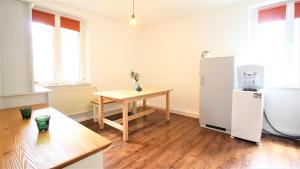 a kitchen with a small table and a refrigerator at Zentral Wohnen - inkl. privatem Stellplatz in Würzburg