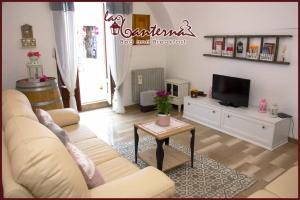 a living room with a couch and a tv at "B&B La Lanterna" in Alberobello