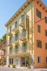 a building with balconies on the side of it at Hotel Centrale in Garda
