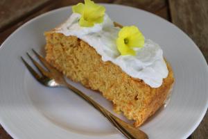 a piece of cake on a white plate with a fork at Aperanti Agrotourism in Pera Orinis