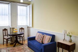 sala de estar con sofá azul y mesa en Porto.arte downtown apartment, en Oporto