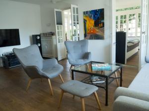 a living room with two chairs and a glass table at Ferienwohnung am Rheinsteig in Bendorf