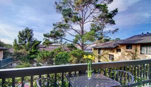 a vase of flowers on a table on a balcony at Wayside Inn in Carmel