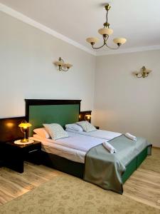 a bedroom with a large bed in a room at Nocowanie Restauracja Wenecka in Kłobuck