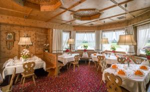 a dining room with white tables and chairs and windows at Hotel Cafe-Zillertal in Strass im Zillertal
