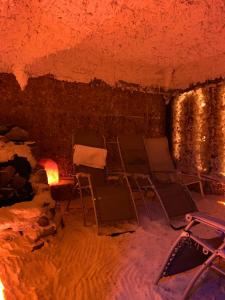 um quarto com cadeiras e uma lareira numa caverna em Nocowanie Restauracja Wenecka em Kłobuck