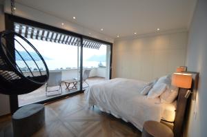 a bedroom with a bed and a large window at Le Terrazze, Via Selvalunga 1, Stresa in Stresa