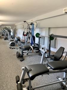 a gym with several exercise equipment in a room at Nocowanie Restauracja Wenecka in Kłobuck